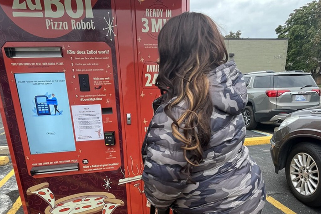 Woman paying at ZaBot pizza machine